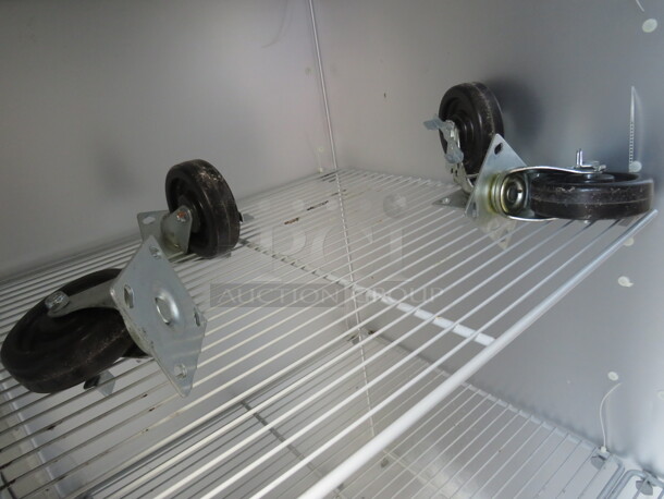 One WORKING 3 Door Stainless Steel Traulsen Refrigerator With 9 Racks, On Casters. 115 Volt. Model# G30011. 77X35X83.5. $9176.00. - Image 3 of 6