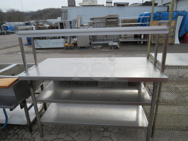 One Stainless Steel Table With 2 SS Under Shelves, And 1 Over Ticket Rail. 60X30X56