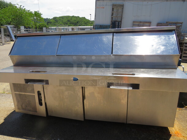 One Randell 3 Door Refrigerated Pizza Prep Table On Casters. WORKING WHEN REMOVED. Model# PH96E3. 115 Volt. 96X40.5X55 - Image 1 of 2