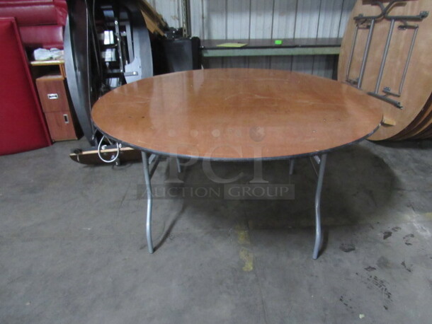 One 60 Inch Round Wooden Folding/Banquet Table With Metal Legs, And A Clear Coat Finish. $523.00. 60X30  - Image 1 of 2