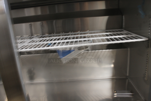 BRAND NEW SCRATCH AND DENT!  Avantco 178SSWT60FHC Commercial Stainless Steel Two Door Worktop Freezer With Backsplash, Polycoated Racks And Commercial Casters. 115V. Tested and Working! - Image 5 of 8