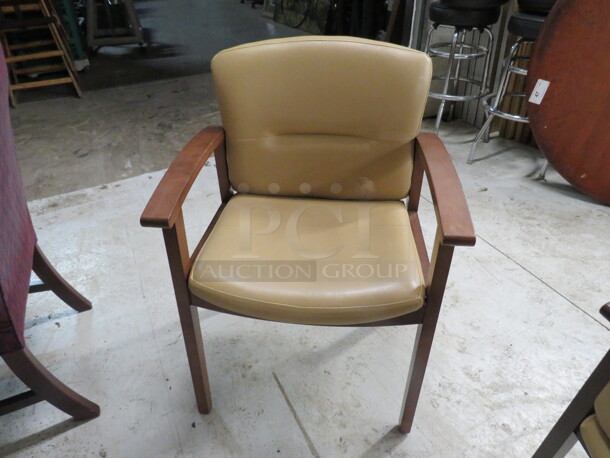 One Wooden Arm Chair With A Beige Cushioned Seat And Back. 