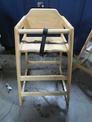 One Wooden High Chair With Safety Straps.
