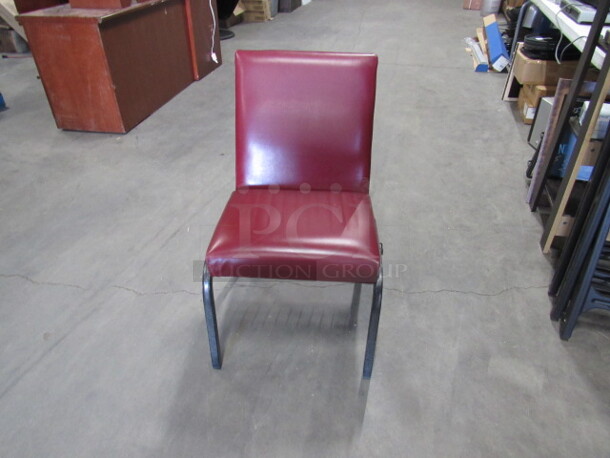 Black Metal Stack Chair With Red Cushioned Seat And Back. 4XBID.