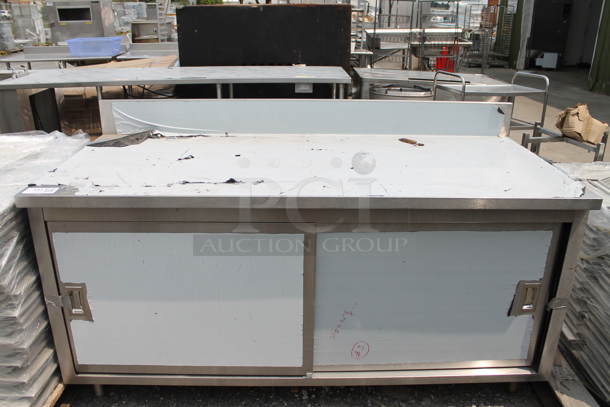 BRAND NEW SCRATCH AND DENT! Stainless Steel Commercial Table w/ Back Splash and 2 Doors.  - Image 1 of 5