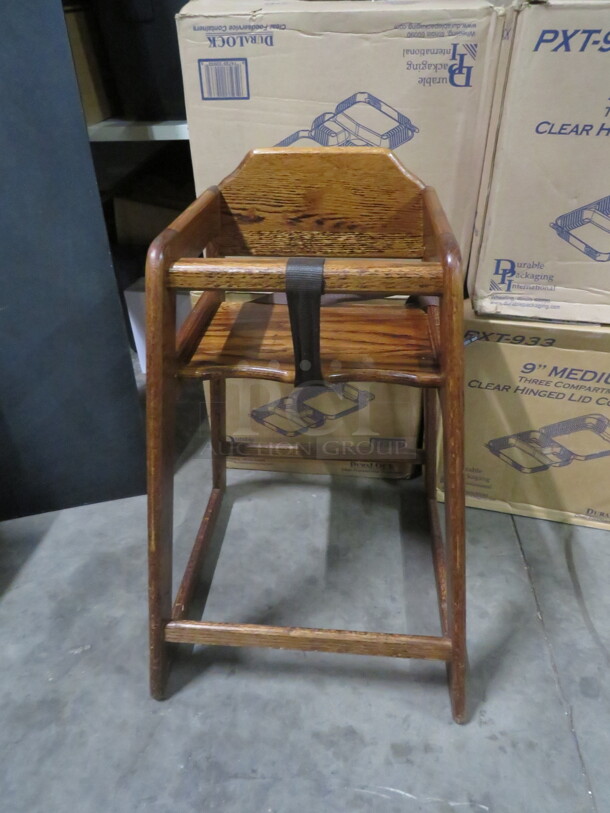 One Wooden High Chair With Safety Straps.