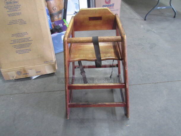 One Wooden High Chair With Safety Straps.