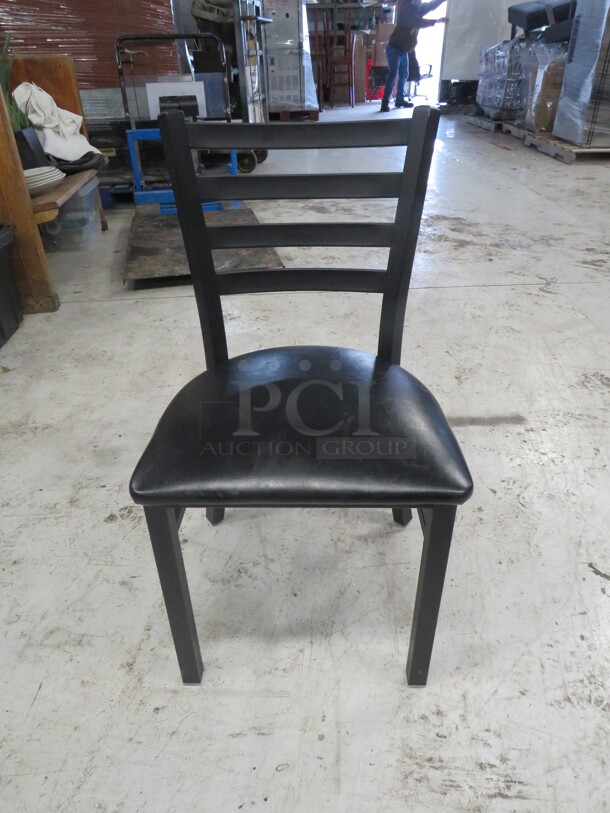 Black Metal Chair With A Black Cushioned Seat. 4XBID - Item #1108077