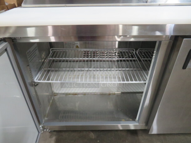 One Working Avantco 2 Door Refrigerated Prep Table With 2 Racks, And  Cutting Board On Casters. Model# 178APT60HC. 115 Volt. 60X31X43. - Image 3 of 5