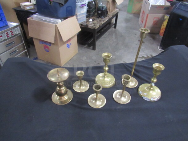 One Lot Of 7 Brass Candle Holders.