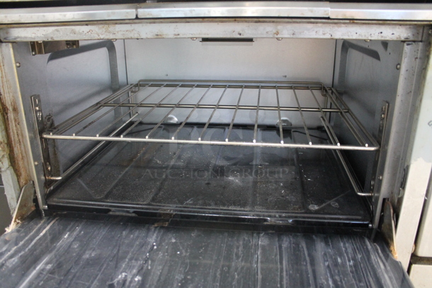 Garland SunFire Stainless Steel Commercial Natural Gas Powered 6 Burner Range w/ Right Side Flat Top Griddle, 2 Ovens, Over Shelf and Back Splash.  - Image 6 of 9