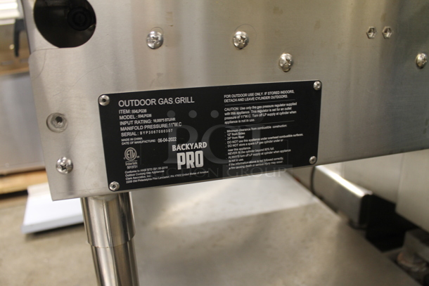 LIKE NEW! 2022 Backyard Pro 554LPG36 Stainless Steel Commercial Propane Gas Powered Outdoor Grill w/ Brick Oven Attachment and Under Shelf on Commercial Casters. Stock Picture Used as Gallery. Tested and Working! - Image 7 of 7