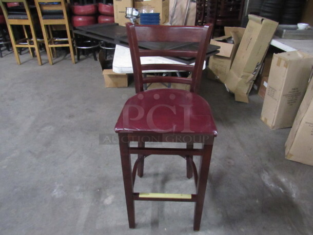 One Wooden Bar Height Chair With Red Cushioned Seat And Footrest. 
