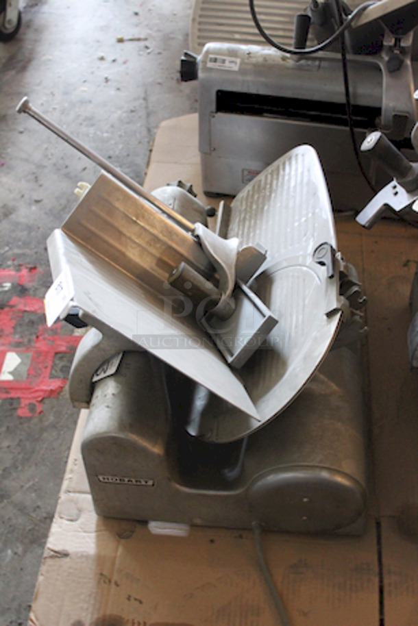 SOLID! Hobart 1612E Deli Slicer, Working When Tested Slice Thickness: 1 1/4". Knife Diameter: 11 3/4". Capacity: Food up to 12"W or 7 1/2" in diameter. Volts: 115. Hertz: 60. Single Phase. Amps: 4.5. Horse Power: 1/4; 23-5/8"W x 26-1/4"D x 21-1/4"H - Image 2 of 4