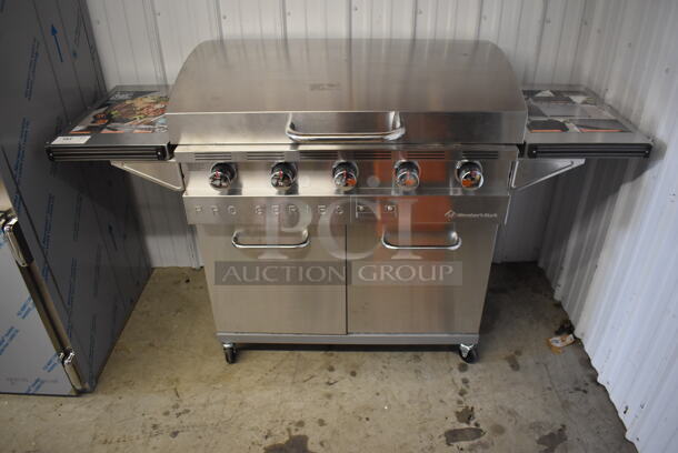 BRAND NEW IN BOX! Members Mark Pro Series G70302/G70302-1 Stainless Steel Commercial 5 Burner Propane Gas Powered Flat Top Griddle Portable Grill on Commercial Casters. Stock Picture Used For Gallery Picture.