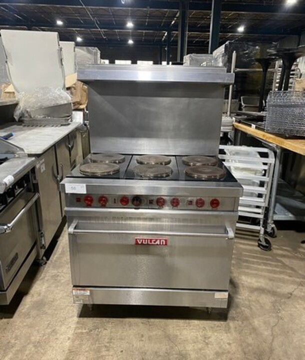 Nice! Vulcan Commercial 6 Burner Stove! With Raised Back Splash And Salamander Shelf! With Oven Underneath! Metal Oven Racks! All Stainless Steel! Model E36 Serial 485! 208/240V 1 Phase! Working When Removed! On Legs!