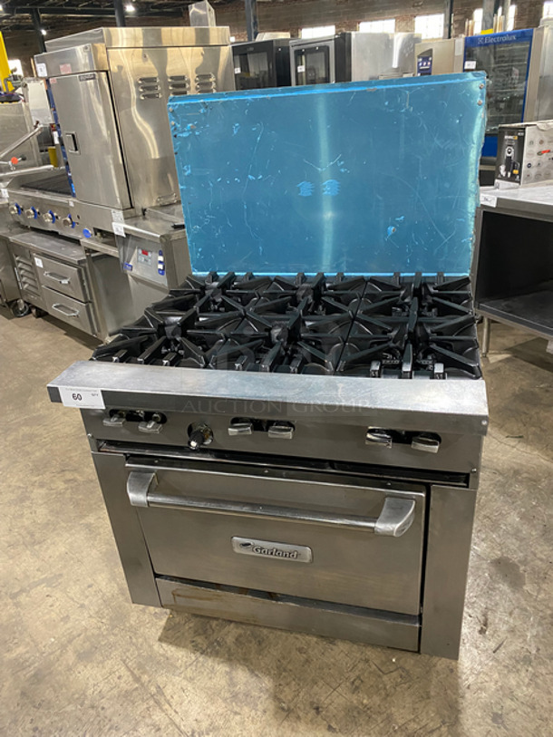 Garland Commercial Natural Gas Powered 6 Burner Stove! With Raised Back Splash! With Oven Underneath! Metal Oven Rack! All Stainless Steel! On Casters!