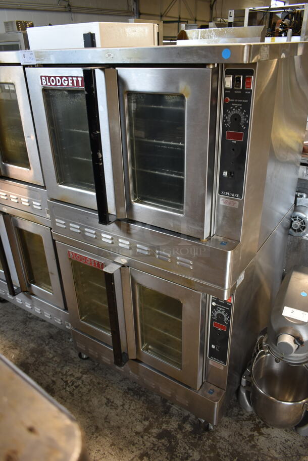 2 Blodgett Zephaire-200-G Stainless Steel Commercial Natural Gas Powered Full Size Convection Ovens w/ View Through Doors, Metal Oven Racks and Thermostatic Controls on Commercial Casters. 60,000 BTU. 2 Times Your Bid!