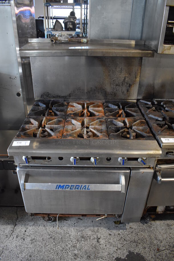 Imperial Stainless Steel Commercial Natural Gas Powered 4 Burner Range w/ Oven, Over Shelf and Back Splash on Commercial Casters. 36x34x57