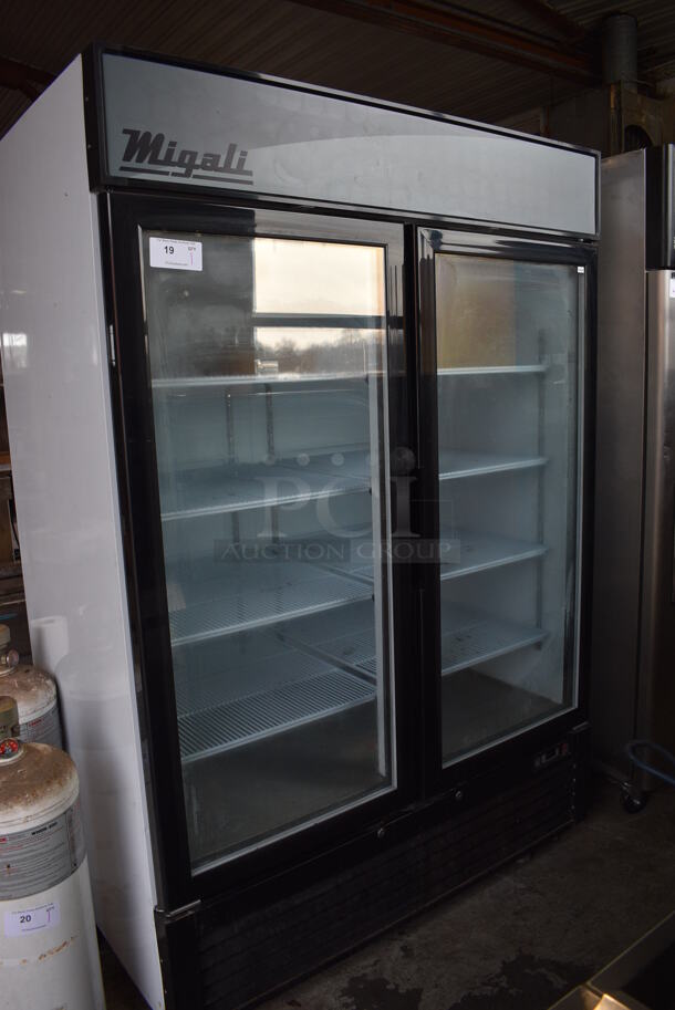 2016 Migali Model C-49FM Metal Commercial 2 Door Reach In Cooler Merchandiser w/ Poly Coated Racks on Commercial Casters. 115 Volts, 1 Phase. 52x32x81. Cannot Test Due To Cut Power Cord