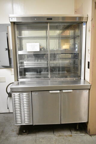 Delfield Stainless Steel Commercial Refrigerated Prep Table w/ 2 Lower Doors. BUYER MUST REMOVE: Bring Tools and Manpower Needed To Remove This Item. This Unit Was In Working Condition When the Restaurant Closed. (kitchen entryway)