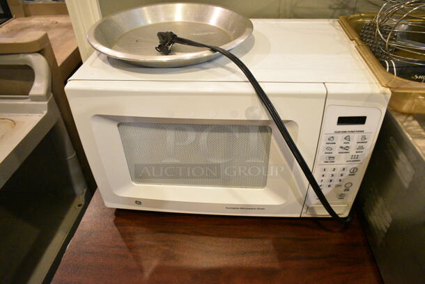 Wood Pattern Dining Height Table w/ Contents Including Avantco Food Warmer, General Electric Microwave, Utensils. (main dining room) - Image 4 of 4