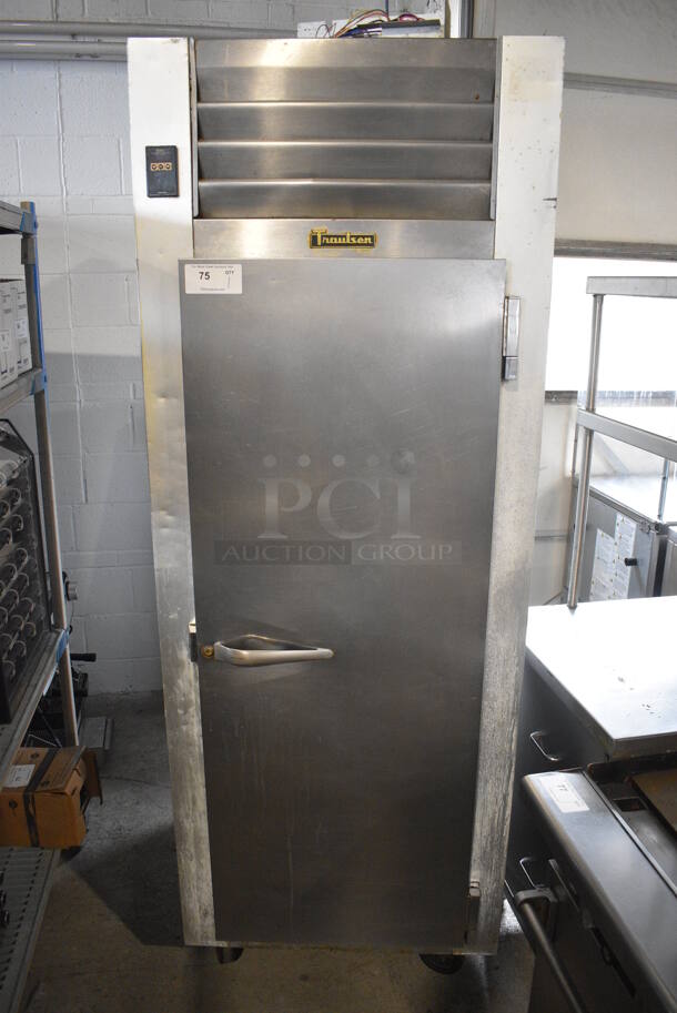 Traulsen Model G12010 Stainless Steel Commercial Single Door Reach In Freezer w/ Poly Coated Racks on Commercial Casters. 115 Volts, 1 Phase. 30x34x83. Tested and Powers On But Temps at 56 Degrees