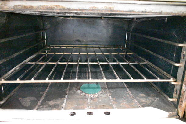 Garland M44R Stainless Steel Commercial Floor Style Natural Gas Powered 4 Burner Range w/ Oven, Over Shelf and Back Splash on Commercial Casters.  - Image 5 of 7