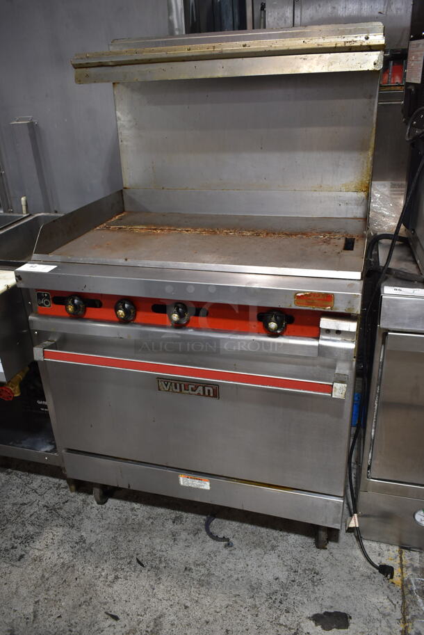 Vulcan 36XTL-559 Stainless Steel Commercial Propane Gas Powered Flat Top Griddle w/ Oven, Over Shelf and Back Splash on Commercial Casters.  - Image 1 of 6