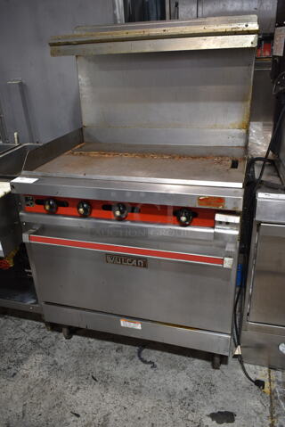 Vulcan 36XTL-559 Stainless Steel Commercial Propane Gas Powered Flat Top Griddle w/ Oven, Over Shelf and Back Splash on Commercial Casters. 