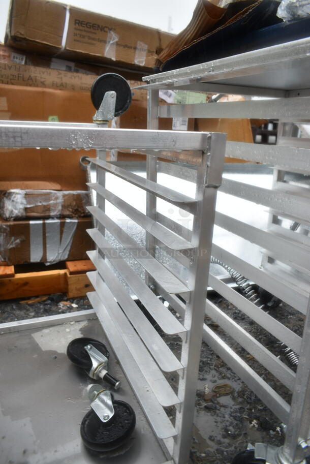 BRAND NEW SCRATCH AND DENT! Regency 600UPR8WTELS 8 Pan End Load Aluminum Undercounter Bun / Sheet Pan Rack with Stainless Steel Top. 2 Casters Need To Be Attached.  - Image 6 of 7