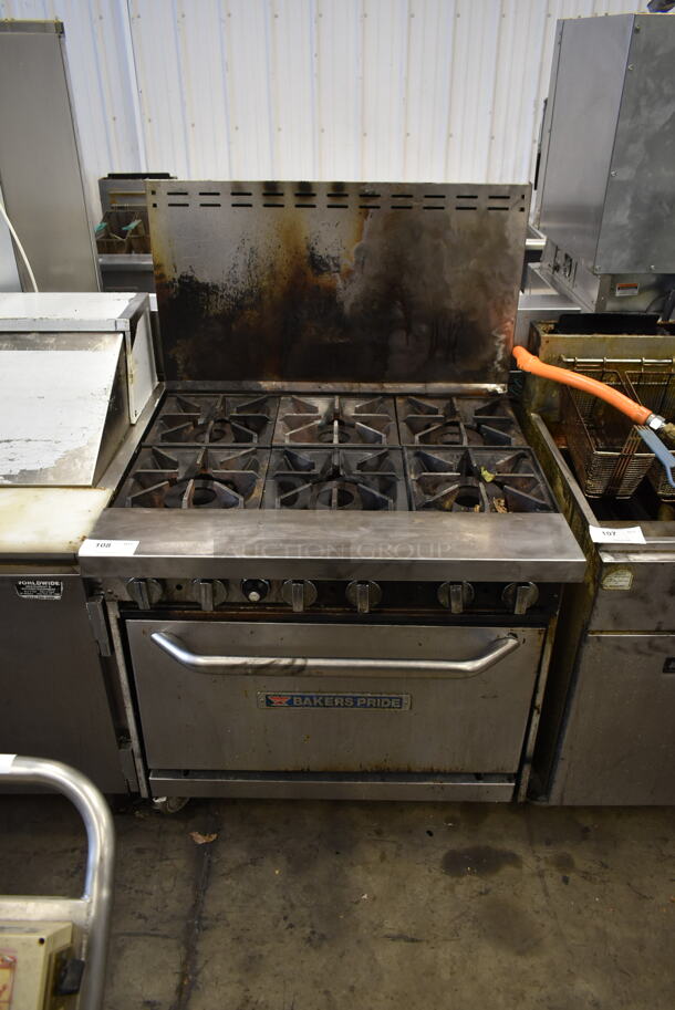Bakers Pride Stainless Steel Commercial Natural Gas Powered 6 Burner Range w/ Oven and Back Splash on Commercial Casters. - Image 1 of 7