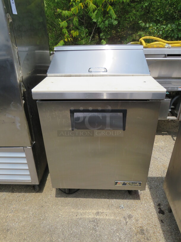 One SS True 1 Door Refrigerated Prep Table With Cutting Board, And 2 Racks On Casters. Model# TSSU-27-08. 115 Volt. 27.5X30X43. $2484.00 - Image 1 of 2