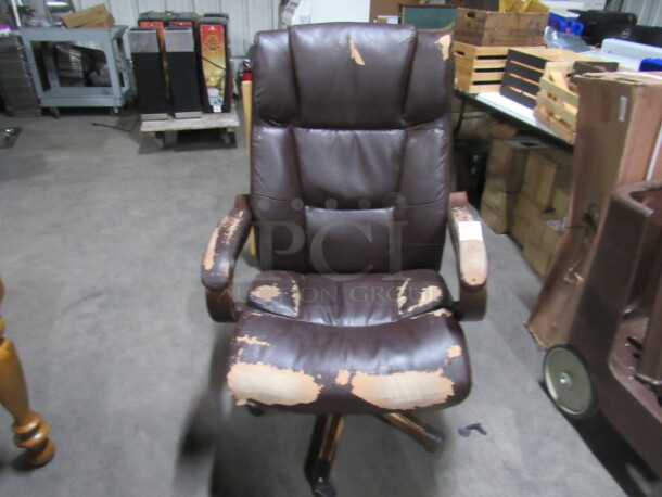 One Brown Pleather Broyhill Office Chair On Casters.