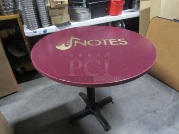 One 36 Inch Round Red Table Top With The NOTES Logo On A Pedestal Base. 36X36X30