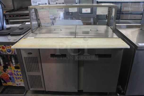 2012 Randell 9030K-7M Commercial Stainless Steel Mega Top Sandwich/Salad Prep Table With Refrigerated Two Door Base And Sneeze Guard On Commercial Casters. 115V, 1 Phase. Tested and Powers On But Does Not Get Cold