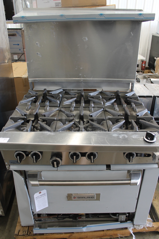 BRAND NEW SCRATCH AND DENT! LATE MODEL! Garland Stainless Steel Commercial Natural Gas Powered 6 Burner Range w/ Convection Oven, Over Shelf and Back Splash.  - Image 2 of 8
