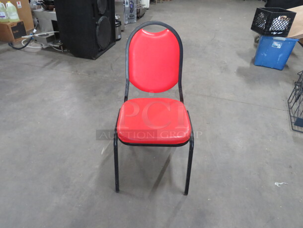 Black Metal Stack Chair With Red Cushioned Seat And Back. 5XBID
