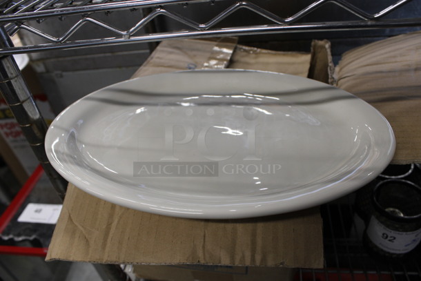 12 BRAND NEW IN BOX! White Ceramic Oval Plates. 12.5x10x1. 12 Times Your Bid!