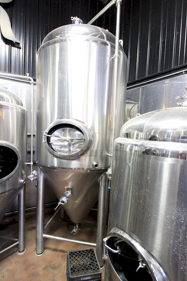 ? ? BEAUTIFUL!! Stout Tanks & Kettles - 15 BBL Fermenter / Unitank (Jacketed). ? ? Features: Easily Converts to a Unitank or Brite Serving Tank; Glycol Jacketed - 2 Zones: Cone and Sidewall; Shadowless Manway for Easy Cleaning; Adjustable Racking Arm for Clear Transfer; 1.5" Sample Valve for Quality Testing; Back Mounted Pressure Gauge; Adjustable Feet for Leveling on Uneven Floors or Fine Height Adjustments; Pressure Gauge Type: Back Mount; CIP Arm and 2.5" Rotating CIP Spray Ball; 2 Butterfly Valves; Rated to 2-Bar (29 PSI); 1/2" NPT Welded Thermowell for Contactless Temperature Probe Tank Thickness: 3mm Jacket and Outer Shell Thickness: 2mm. Cone: 60 degree Interior Angle. 51.5-in. diameter x 125-in.H. - Image 4 of 4
