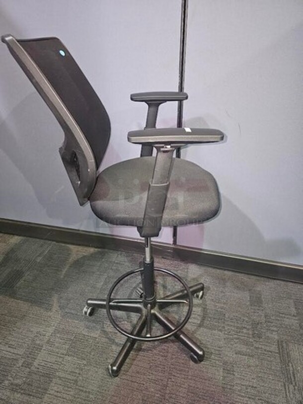 Tall black desk chair on wheels made by Henglin Home Furnishings Co. LTD. Features armrests and is adjustable height. In good used conditions- minor signs of wear. No rips, holes or broken pieces. Measures 52” H x 25” W.  

 - Image 2 of 4