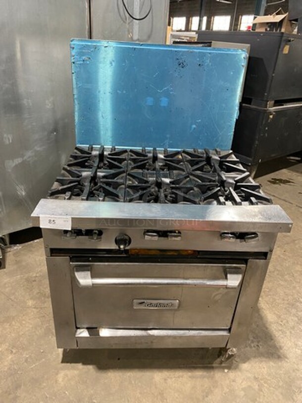 Garland Commercial Natural Gas Powered 6 Burner Stove! With Raised Back Splash! With Oven Underneath! Metal Oven Rack! All Stainless Steel! On Casters!