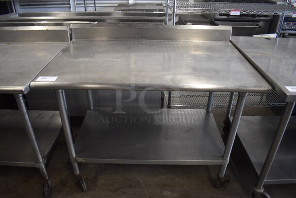 Stainless Steel Commercial Table w/ Under Shelf and Back Splash on Commercial Casters. 48x30x40