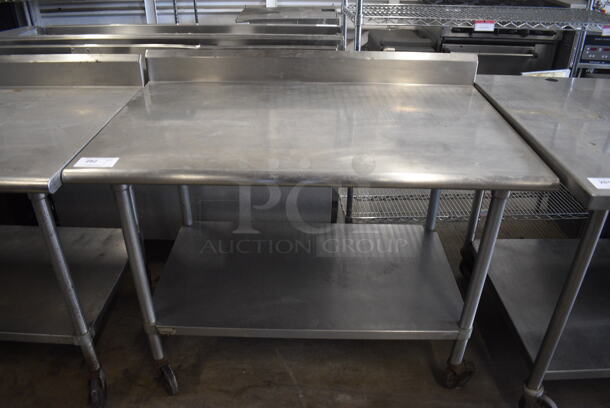 Stainless Steel Commercial Table w/ Under Shelf and Back Splash on Commercial Casters. 48x30x40 - Image 1 of 4