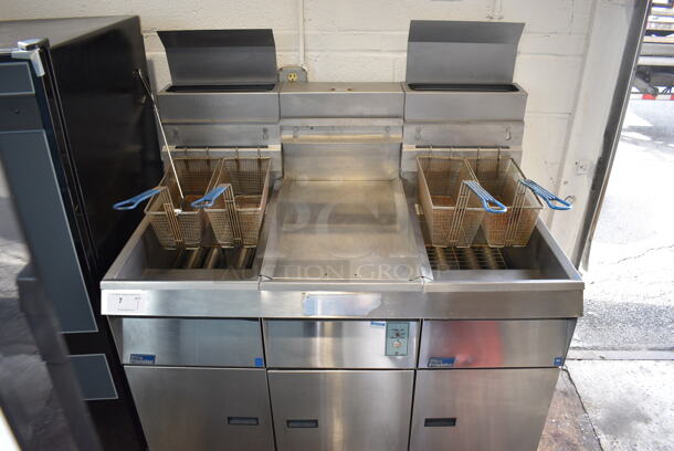 Pitco Frialator Model F14S-V Stainless Steel Commercial Floor Style Propane Gas 2 Bay Fryer w/ Center Dumping Station on Commercial Casters. 110,000 BTU. 49x32x54 - Image 1 of 9