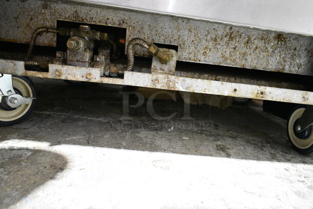 Radiance Stainless Steel Commercial Natural Gas Powered 6 Burner Range w/ Oven, Over Shelf and Back Splash on Commercial Casters. 2 Casters Need To Be Reattached. - Image 4 of 5