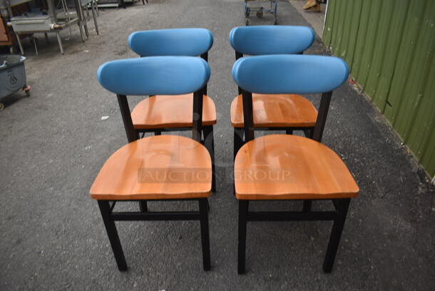 4 Chairs With Black Frame, Wood Style Seat And Blue Cushioned Stretcher. 4 Times Your Bid! Cosmetic Condition May Vary. - Image 1 of 3