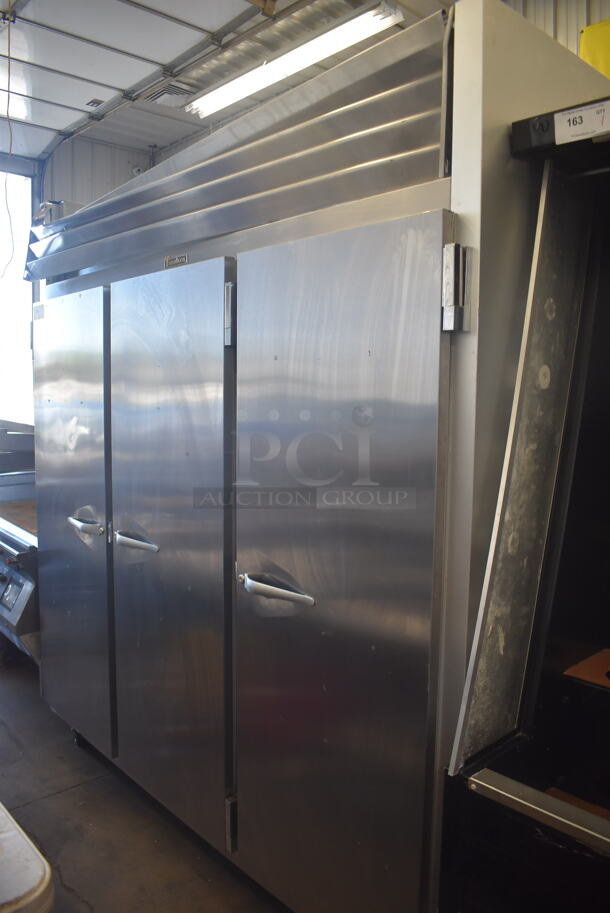 Traulsen G31010 3 Door Stainless Steel Commercial Freezer w/ Poly Coated Racks on Commercial Casters. 115 Volts 1 Phase. Tested and Does Not Power On
