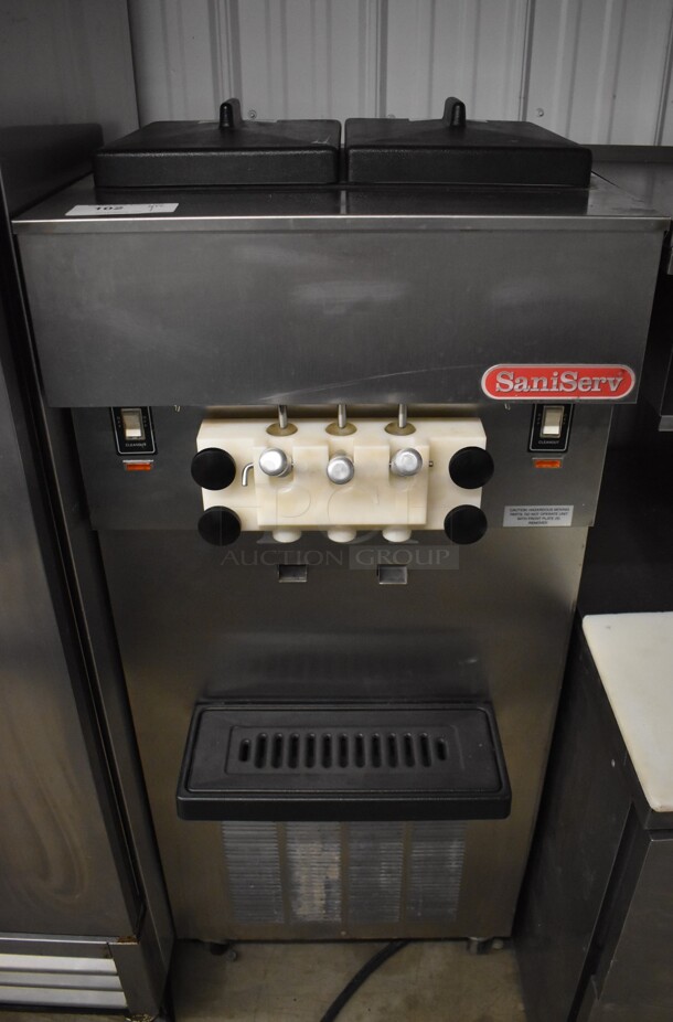 SaniServ W5273P Stainless Steel Commercial Floor Style Air Cooled 2 Flavor w/ Twist Soft Serve Ice Cream Machine on Commercial Casters. 208-230 Volts, 3 Phase. 24x23x59
