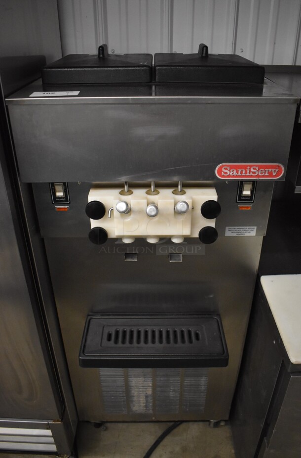 SaniServ W5273P Stainless Steel Commercial Floor Style Air Cooled 2 Flavor w/ Twist Soft Serve Ice Cream Machine on Commercial Casters. 208-230 Volts, 3 Phase. 24x23x59 - Image 1 of 9